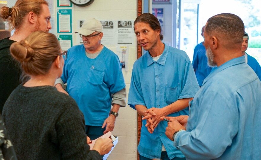 Kelton presenting Earth Equity at a San Quentin event